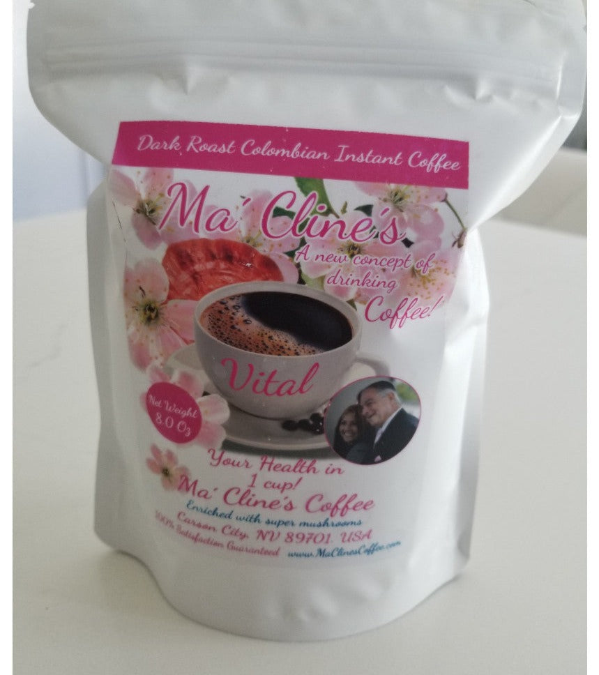 White bag with pink toned front label of Ma' Cline's Vital Instant Coffee. Background photo is pink cherry blossoms, and red ganoderma mushrooms behind a white cup of delicious, steaming coffee.