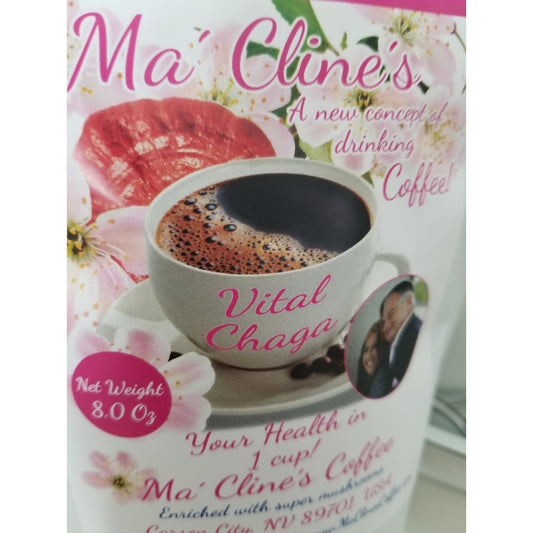 White bag with pink toned front label of Ma' Cline's Vital Instant Coffee. Background photo is pink cherry blossoms, and red ganoderma mushrooms behind a white cup of delicious, steaming coffee.