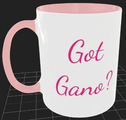 11 ounce traditional shape coffee mug, white with pink interior and pink handle. Decorated with Ma' Cline's logo on one side and the words "Got Gano?" on the other side in pink script.
