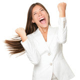 Lady with long hair in a white business suit with fists clenched and arms upraised. Big smile of accomplishment as she screams "Yes!"